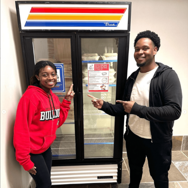 Students posing in front of Wolf Haven fridges.
