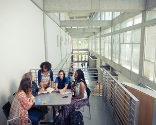 People at a table sharing a book