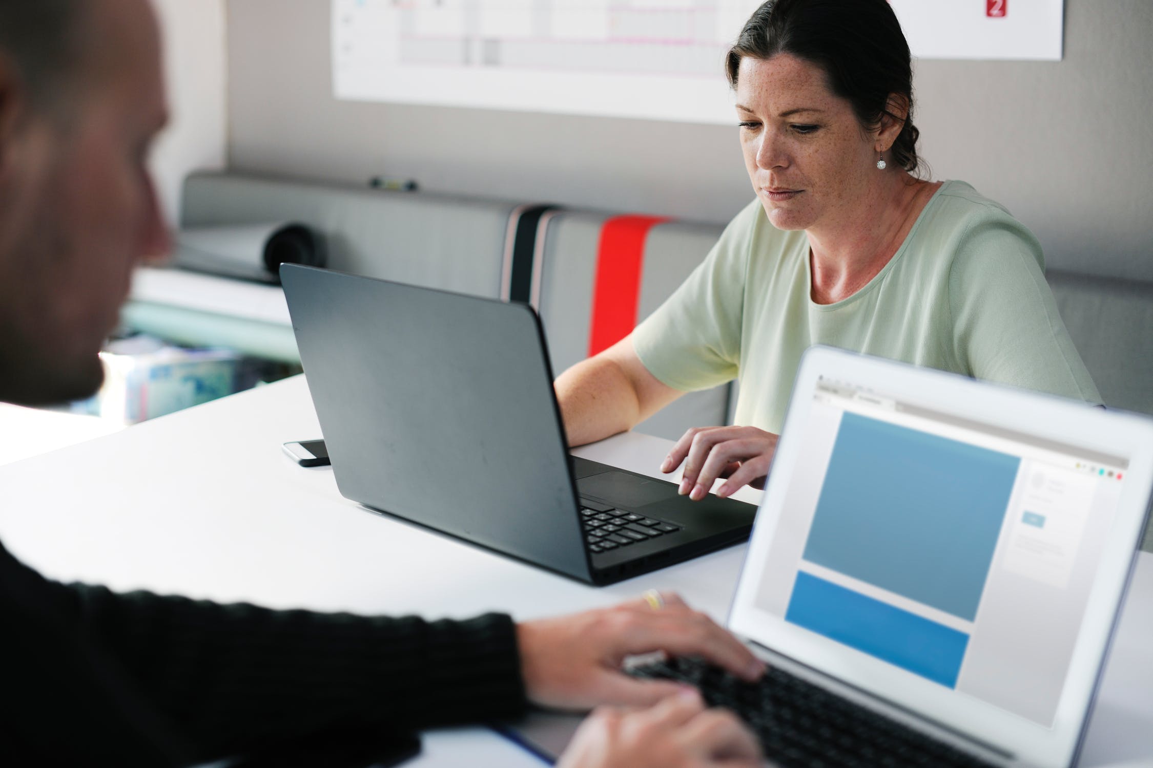 Woman and man working on their laptops