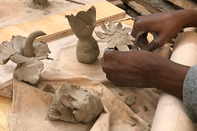 A youth working with clay