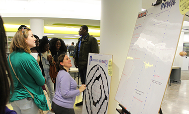 As a study break during finals week, Ingram Library hosted Carrollton resident Sarah Boddy to set up an interactive community crossword puzzle. This event was part of Sarah’s Participatory Democrossy Project. This project stemmed from the issue that the creators of crossword puzzles typically fall into the same demographic, and they’re almost always made by one person at a time.