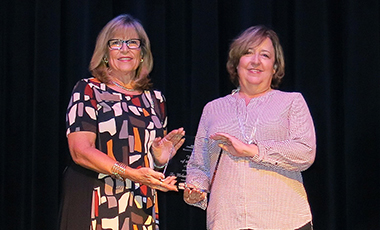 Dr. Melanie McClellan was named the 2016 Woman of the Year by the Carroll Chamber Women’s Business Alliance at their recent luncheon at the Carrollton Cultural Arts Center. Paula Gillispie, the 2015 WBA Woman of the Year, introduced McClellan to the record crowd.