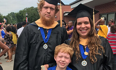 For most people, graduation is a family affair. For one married couple graduating from the University of West Georgia, even a future generation joined the celebration. Ben and Eva Morgan graduated from UWG on July 25, each with a master’s degree in psychology. Their young son James, who is 8 years old, attended the ceremony. Also in attendance were the couples’ twins, due almost at any moment to make their entrance into the world.