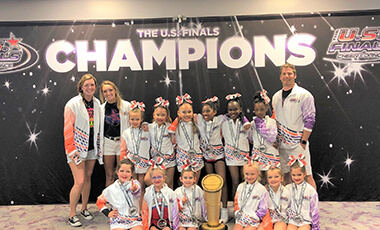 When Spencer Gist was a kid, he had a trampoline in his backyard. He’d flip and flop on it all day, not knowing then that the skills he was learning would enable him to coach a team of cheerleaders to a competitive national stage.