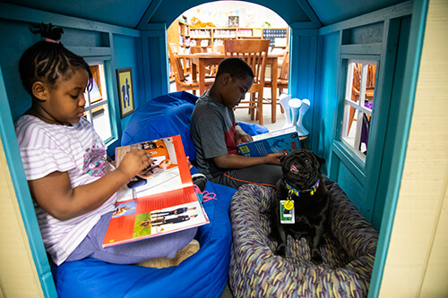 Booker T. Pug and students reading