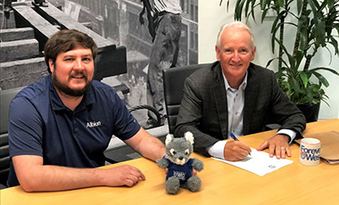 Albion Executive Vice President, Brian Newsome (right), signs off on an endowed scholarship for the University of West Georgia with Jason Strane, project manager.