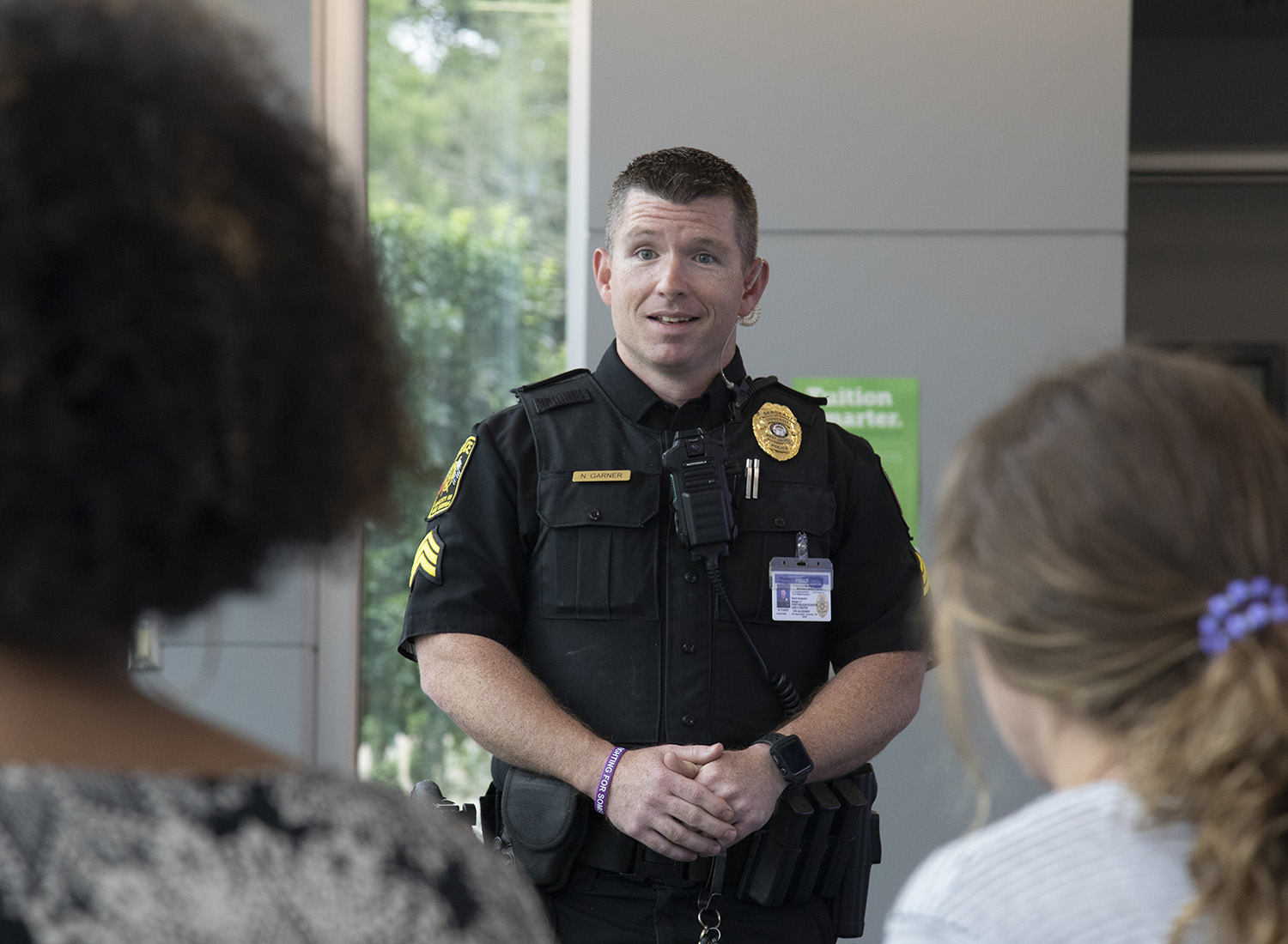 Officer conversing with students.