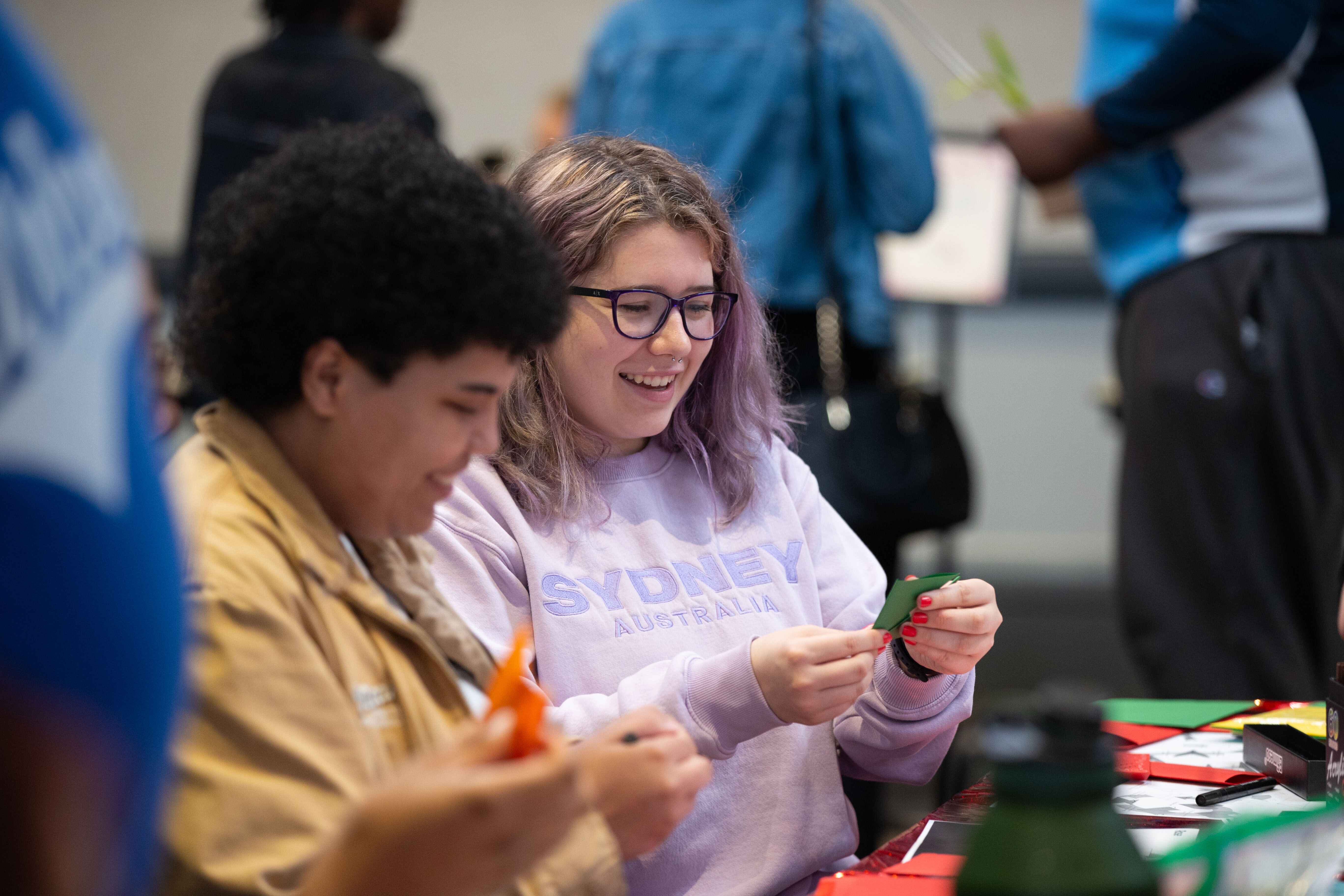 UWG students smiling doing arts and crafts