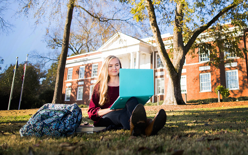 Student sitting on the grass