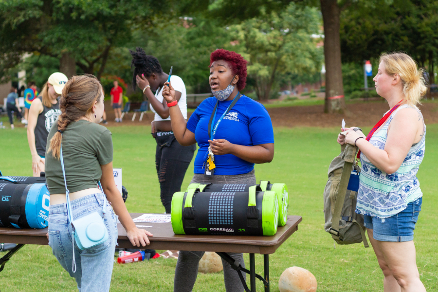 students speaking with uwg employee