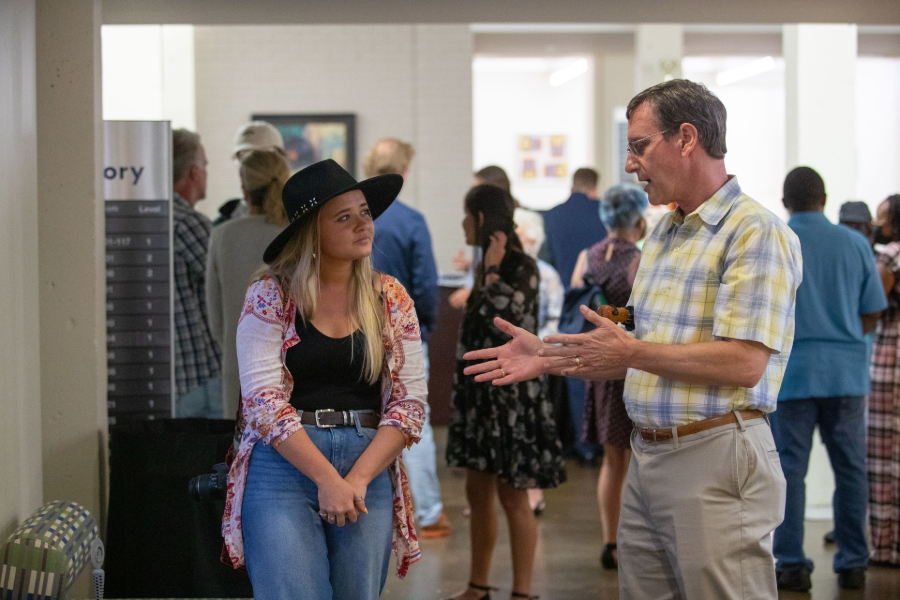 student speaking with faculty