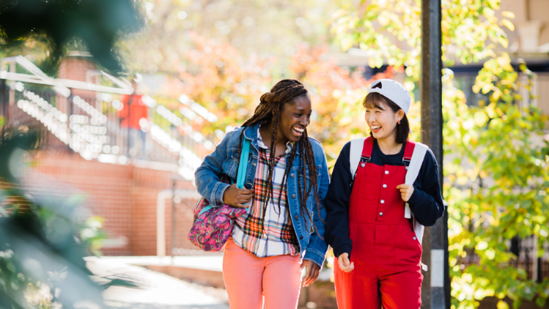 Two students walking on campus