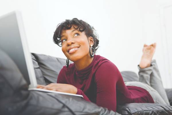 Student with laptop on a couch